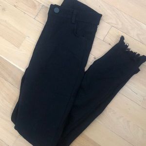 Black distressed jeans with fringe bottoms